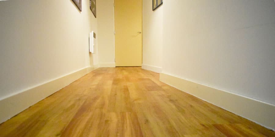 Oak coloured Karndean flooring installed into a hallway in an apartment in Northenden M22