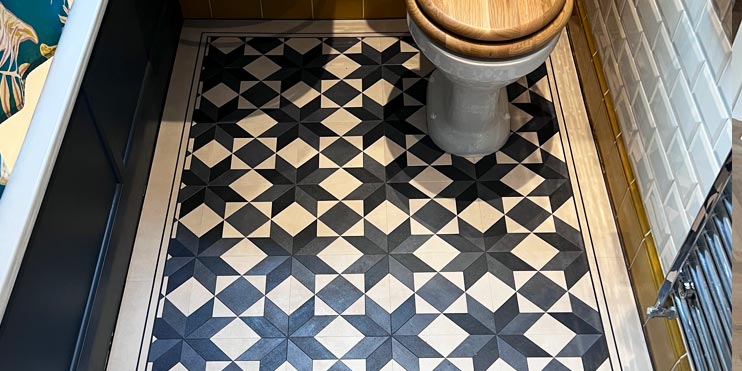 Amtico Victorian inspired tiles in navy blue and cream installed into a family bathroom