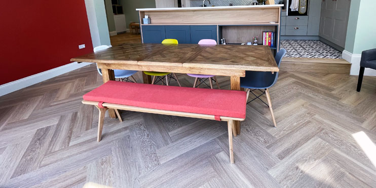 Golden Oak Herringbone flooring installed in a modern multi coloured kitchen
