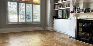 Engineered wood herringbone flooring in natural oak installed in a living room