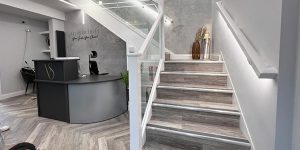 Light grey commercial herringbone flooring installed in the waiting area and stairs in a dental practice in Northendedn, M22